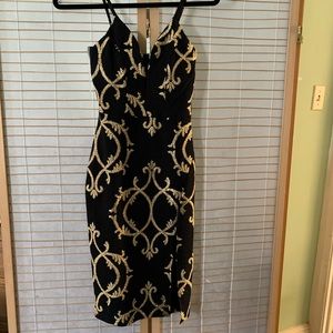 Blue Blush Black and gold dress with high slit